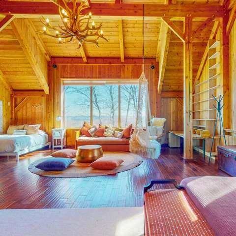 The cabin great room with antler chandelier and window seat