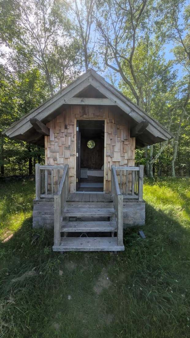A hand-built wooden hut in the woods
