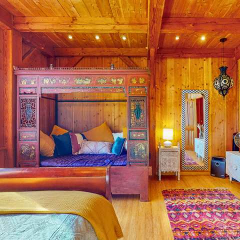 Bedroom with a hand-carved bed and lantern light