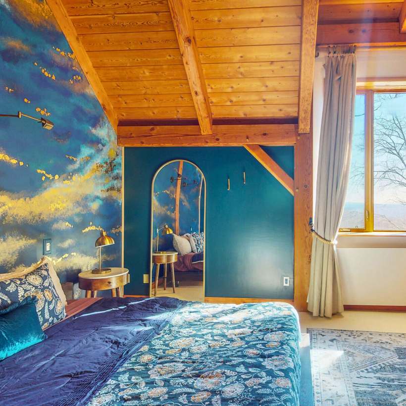 Private cabin room with hand-painted sky mural and timber ceiling