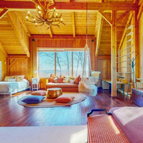 The cabin great room with antler chandelier and window seat